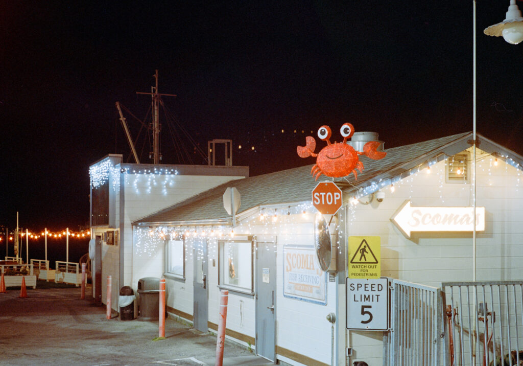 A restaurant on the pier with a crab sign.